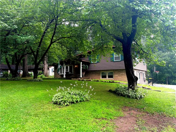 a front view of a house with garden