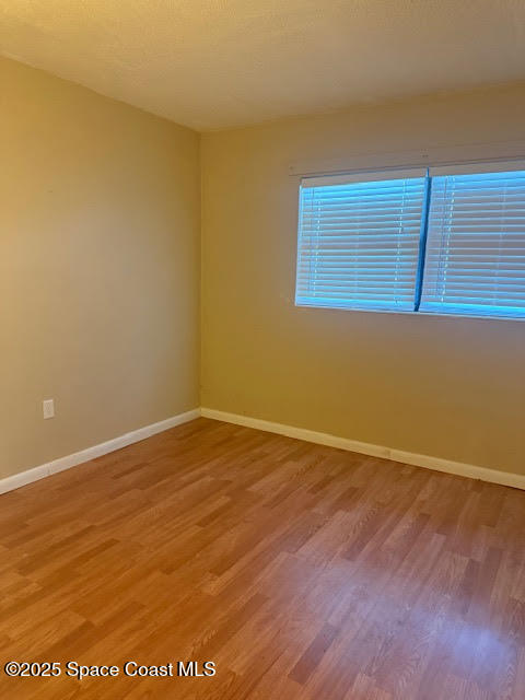 119 Explorer Street Cocoa, FL 32922 - Photo 9 of 19 a view of an empty room with wooden floor and a window