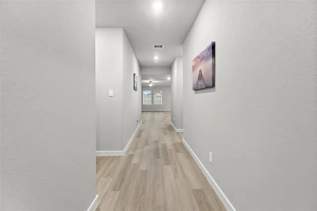 a view of hallway with wooden floor