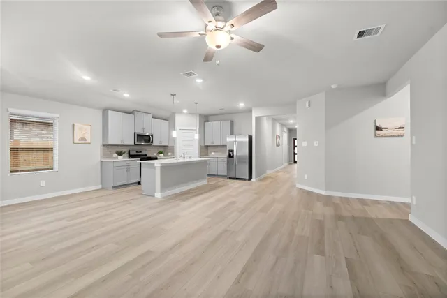 a view of kitchen with refrigerator microwave and stove