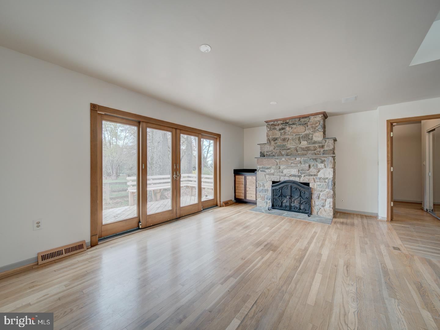 17520 Tranquility Road Purcellville, VA 20132 - Photo 11 of 70 a view of an empty room with a fireplace and a window