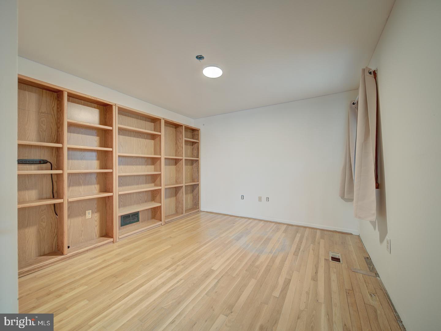 17520 Tranquility Road Purcellville, VA 20132 - Photo 13 of 70 a view of an empty room with a window and wooden floor