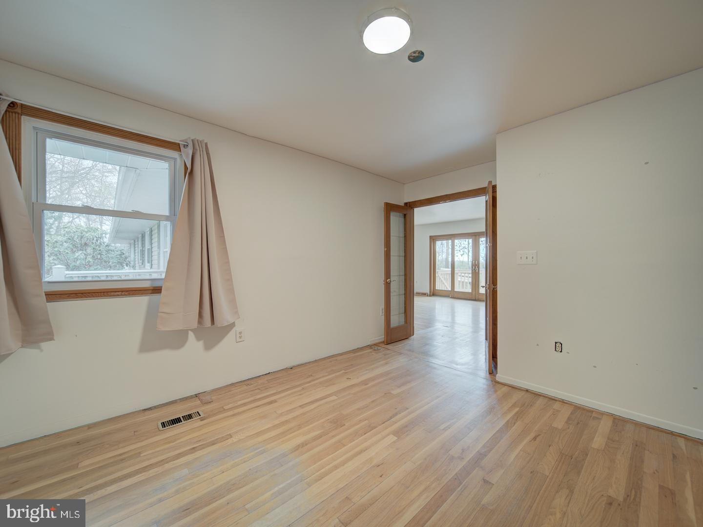 17520 Tranquility Road Purcellville, VA 20132 - Photo 15 of 70 a view of an empty room with wooden floor and a window
