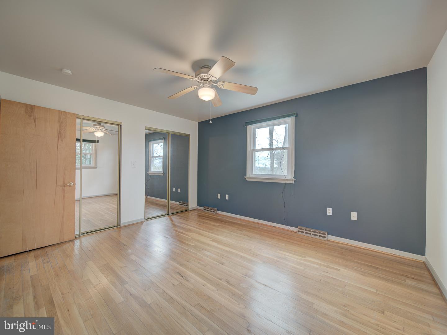 17520 Tranquility Road Purcellville, VA 20132 - Photo 18 of 70 a view of an empty room with window and wooden floor