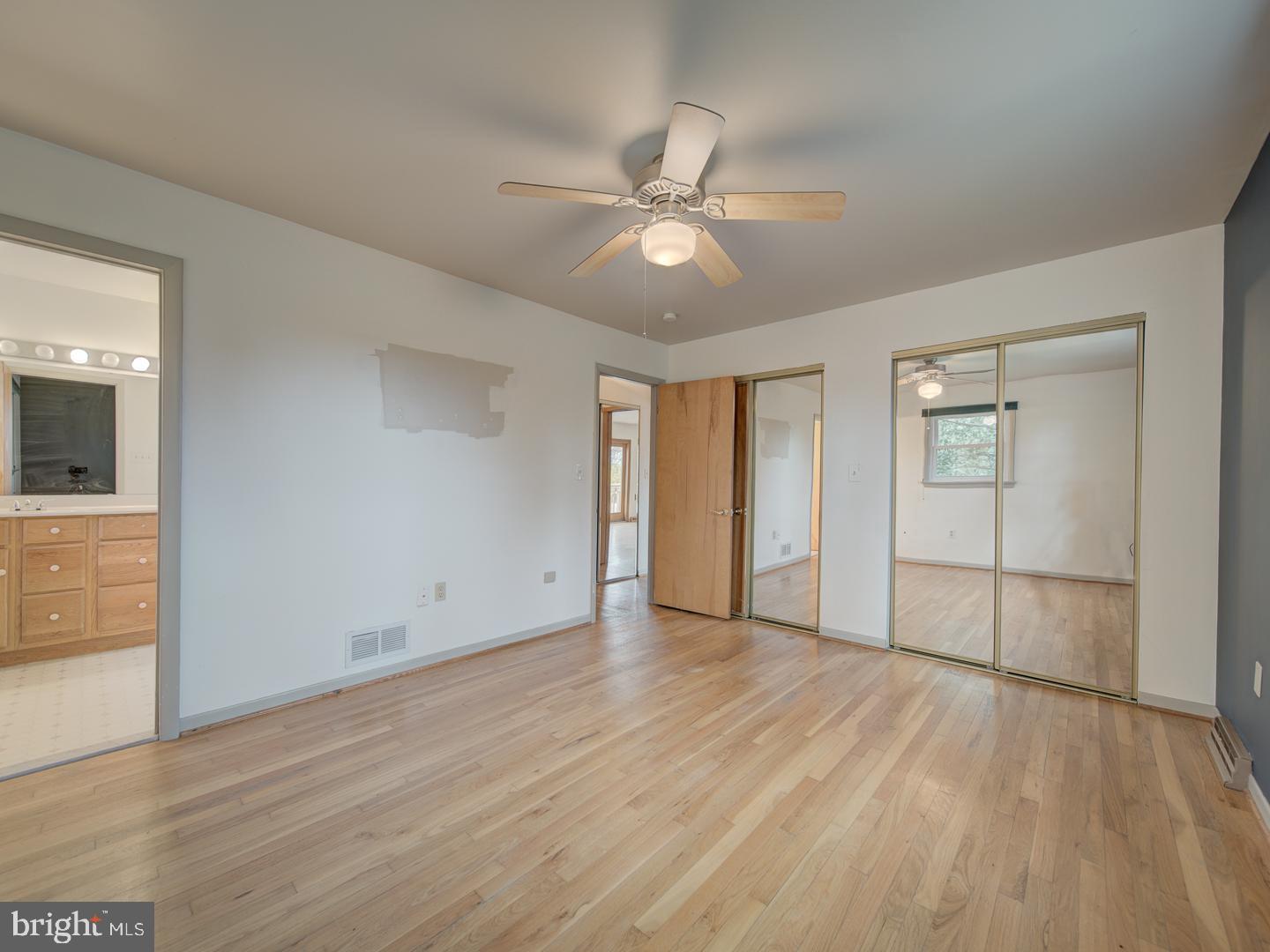 17520 Tranquility Road Purcellville, VA 20132 - Photo 19 of 70 a view of an empty room with wooden floor and a ceiling fan