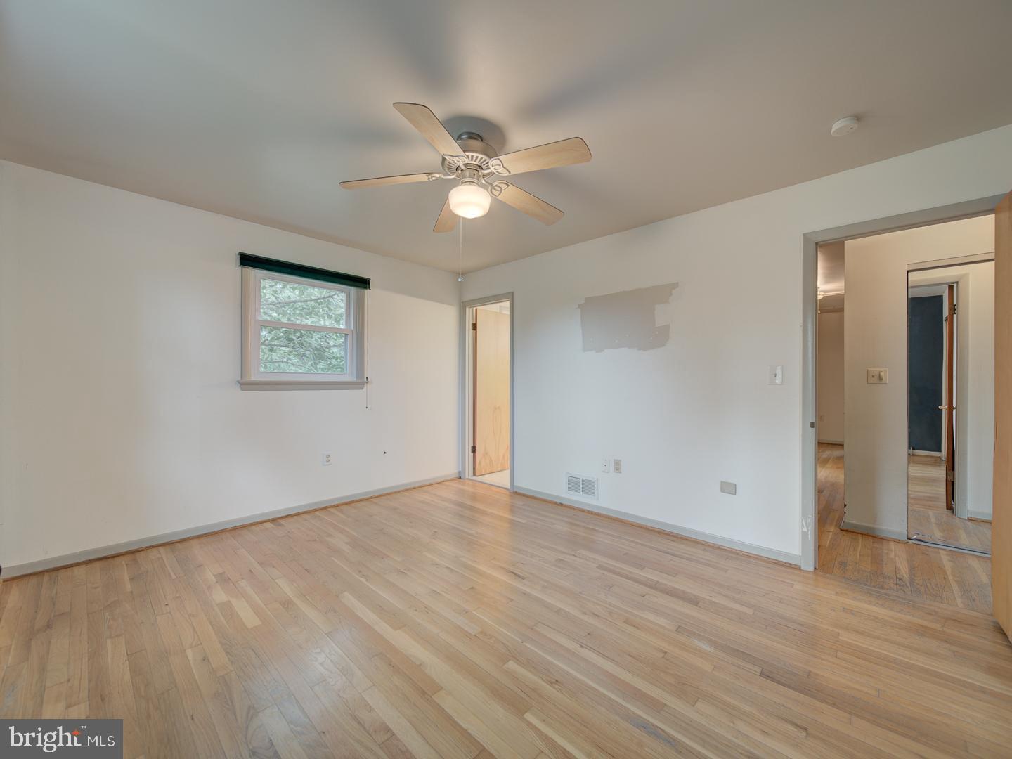 17520 Tranquility Road Purcellville, VA 20132 - Photo 20 of 70 an empty room with wooden floor and windows
