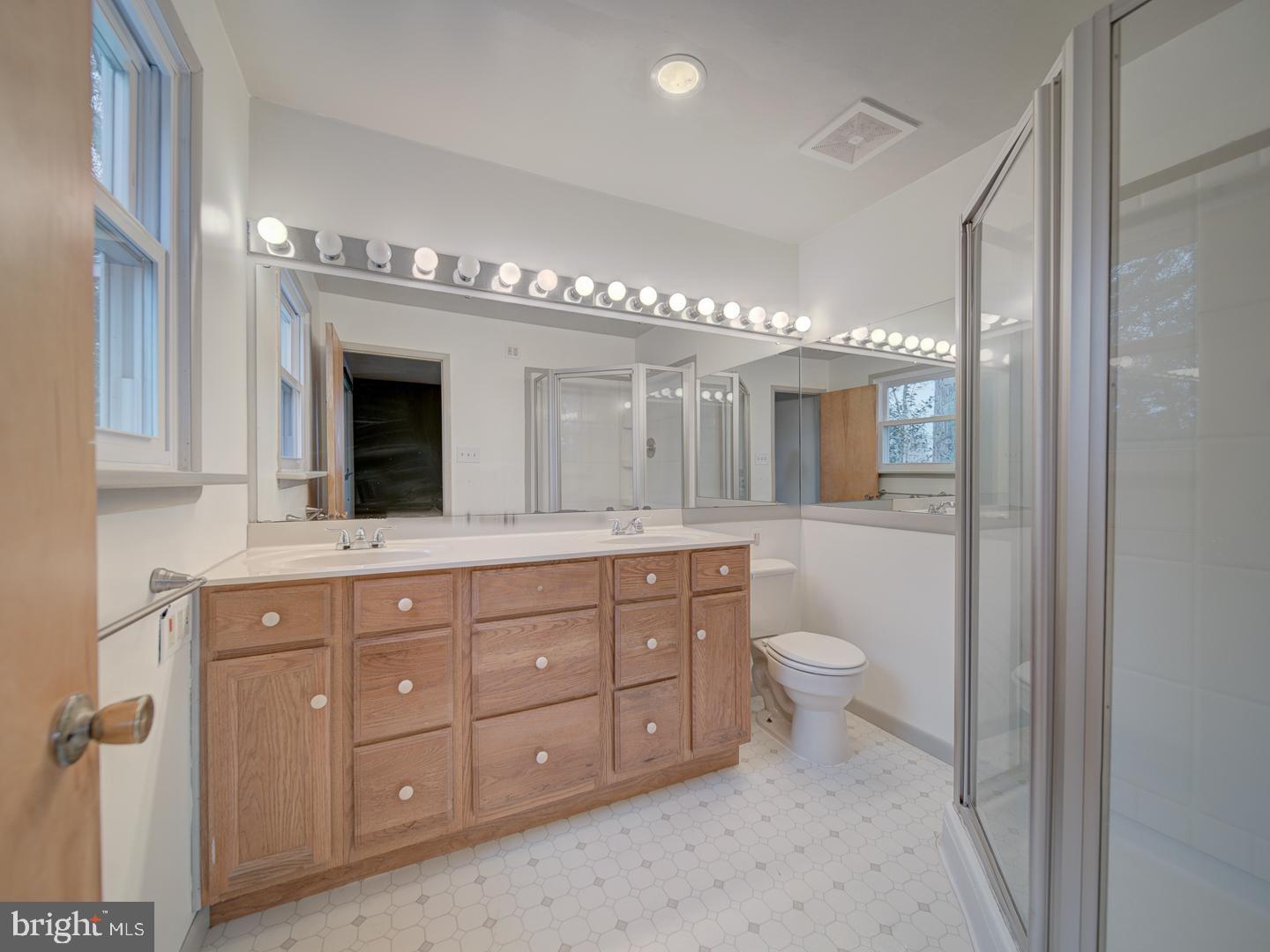 17520 Tranquility Road Purcellville, VA 20132 - Photo 21 of 70 a spacious bathroom with a granite countertop double vanity sink a mirror and a toilet
