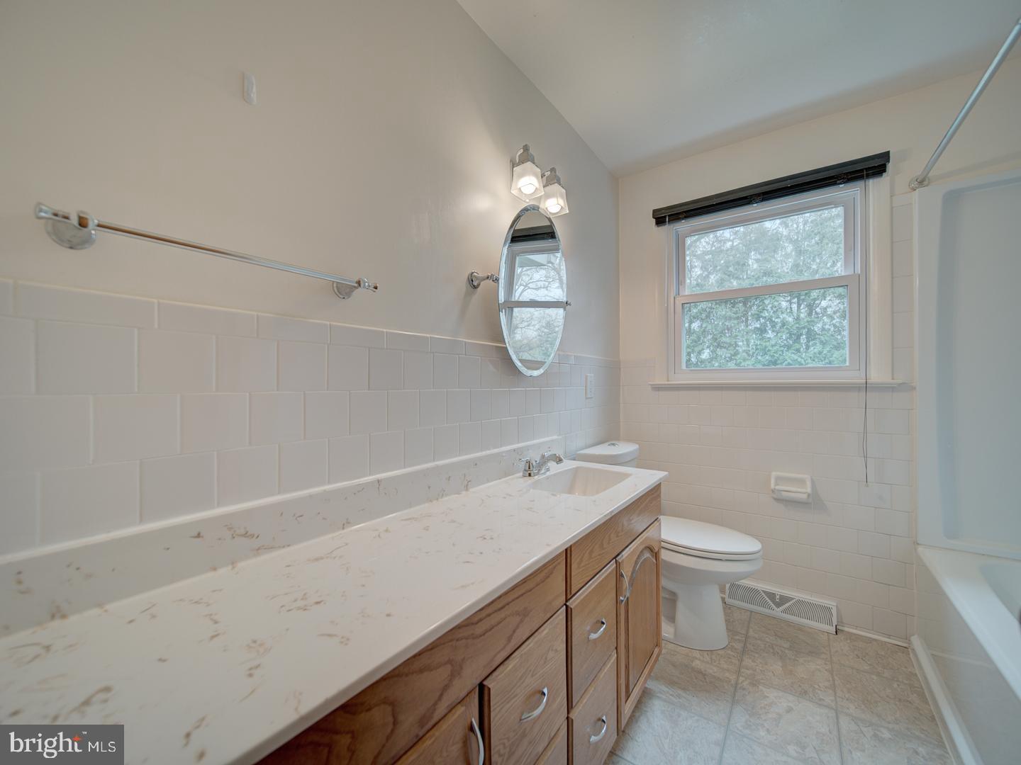 17520 Tranquility Road Purcellville, VA 20132 - Photo 26 of 70 a view of bathroom with a toilet sink and mirror