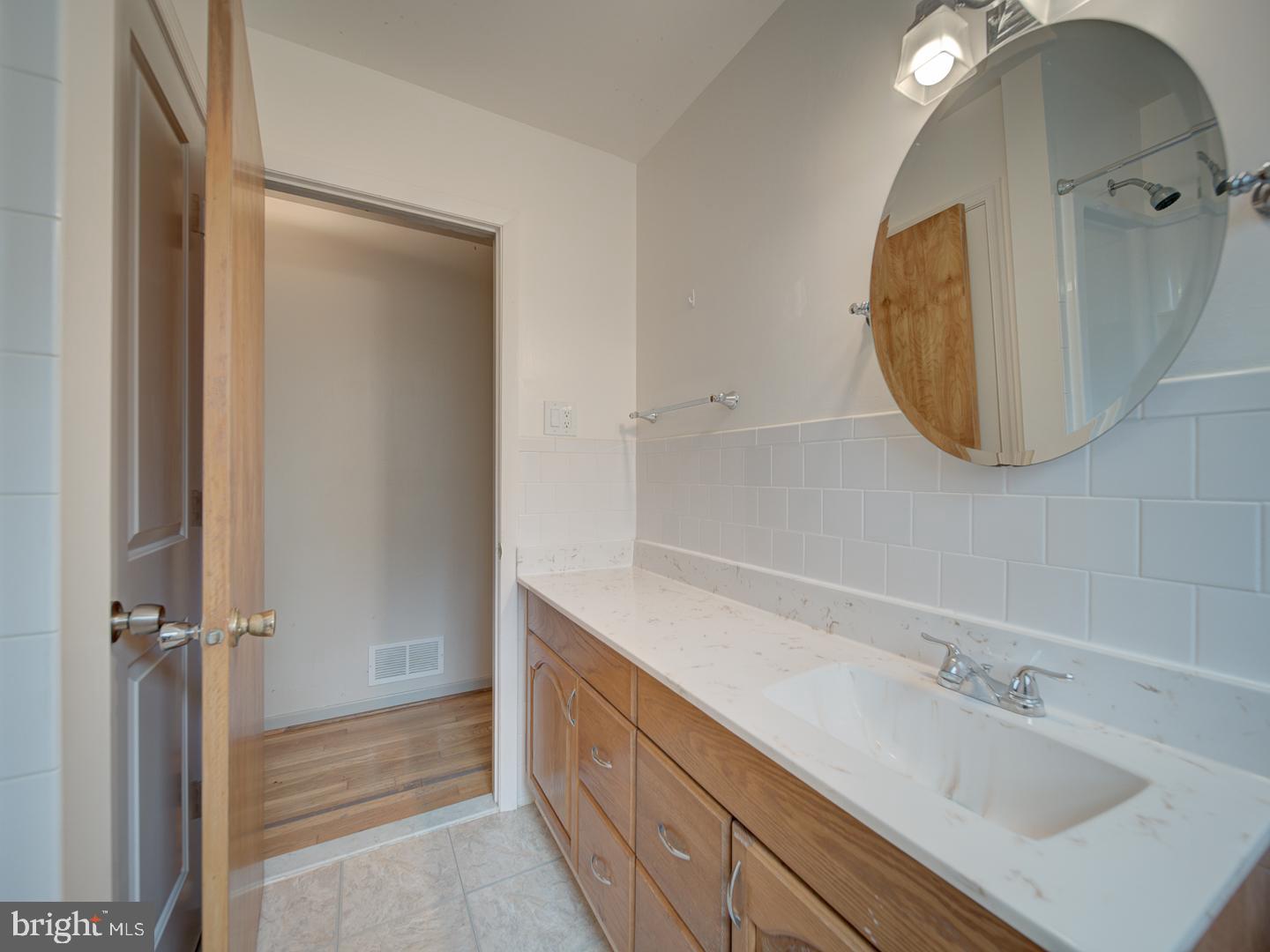 17520 Tranquility Road Purcellville, VA 20132 - Photo 27 of 70 a bathroom with a sink mirror and vanity