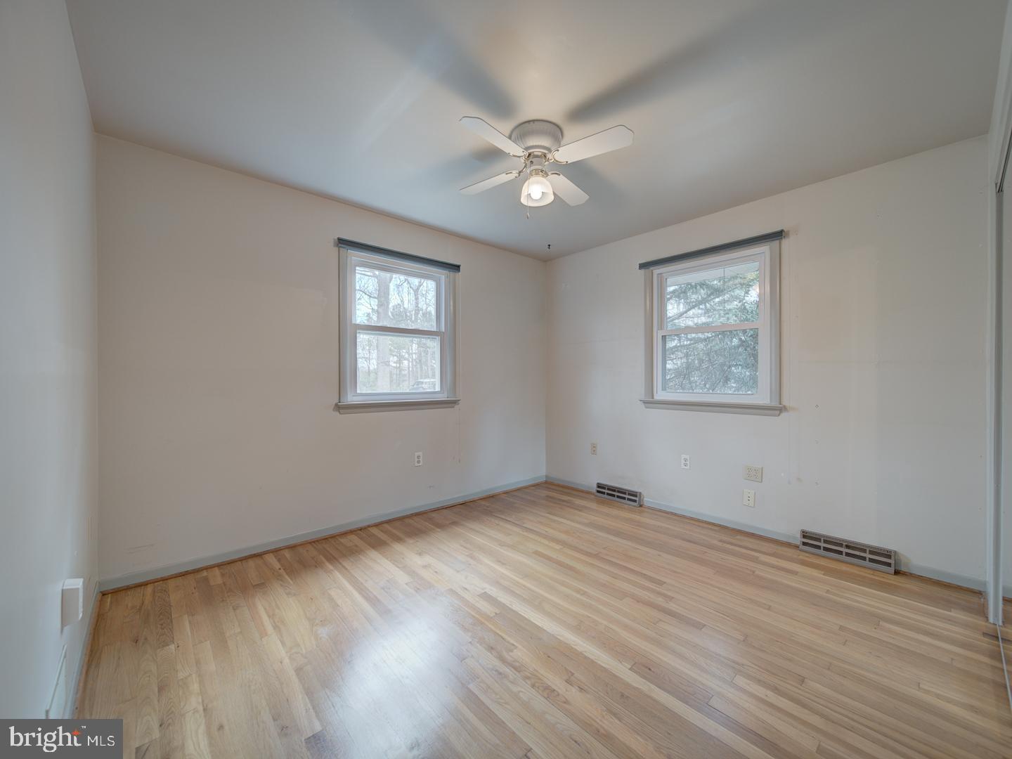 17520 Tranquility Road Purcellville, VA 20132 - Photo 32 of 70 a view of an empty room with wooden floor and a window