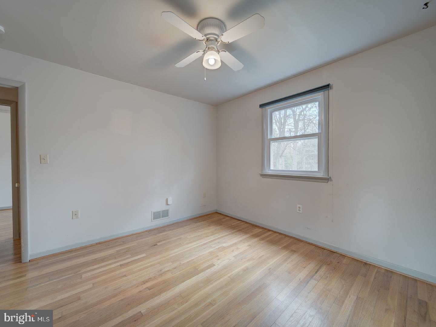 17520 Tranquility Road Purcellville, VA 20132 - Photo 33 of 70 an empty room with wooden floor and ceiling fan