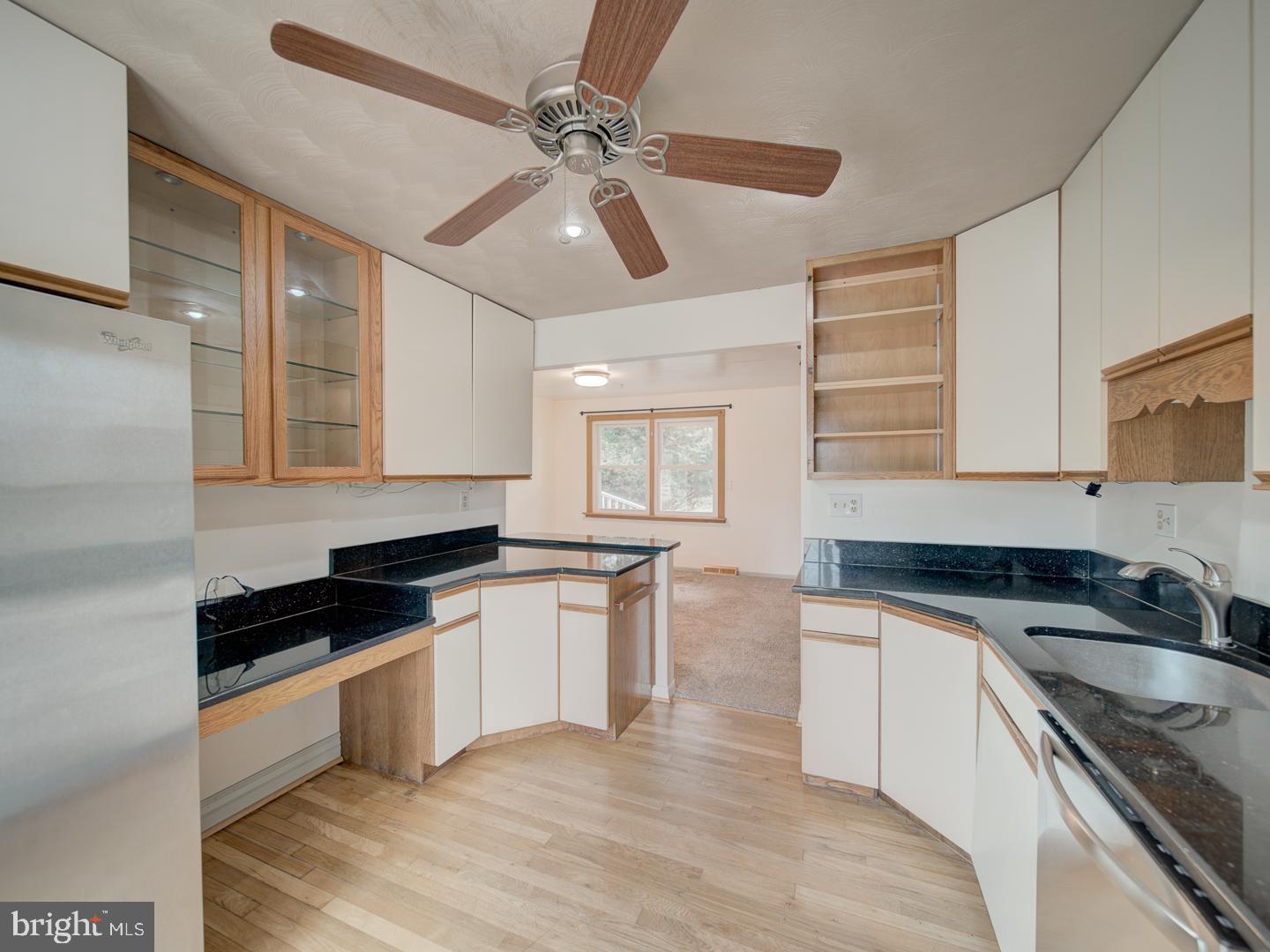 17520 Tranquility Road Purcellville, VA 20132 - Photo 45 of 70 a kitchen with granite countertop stainless steel appliances a sink cabinets and wooden floor