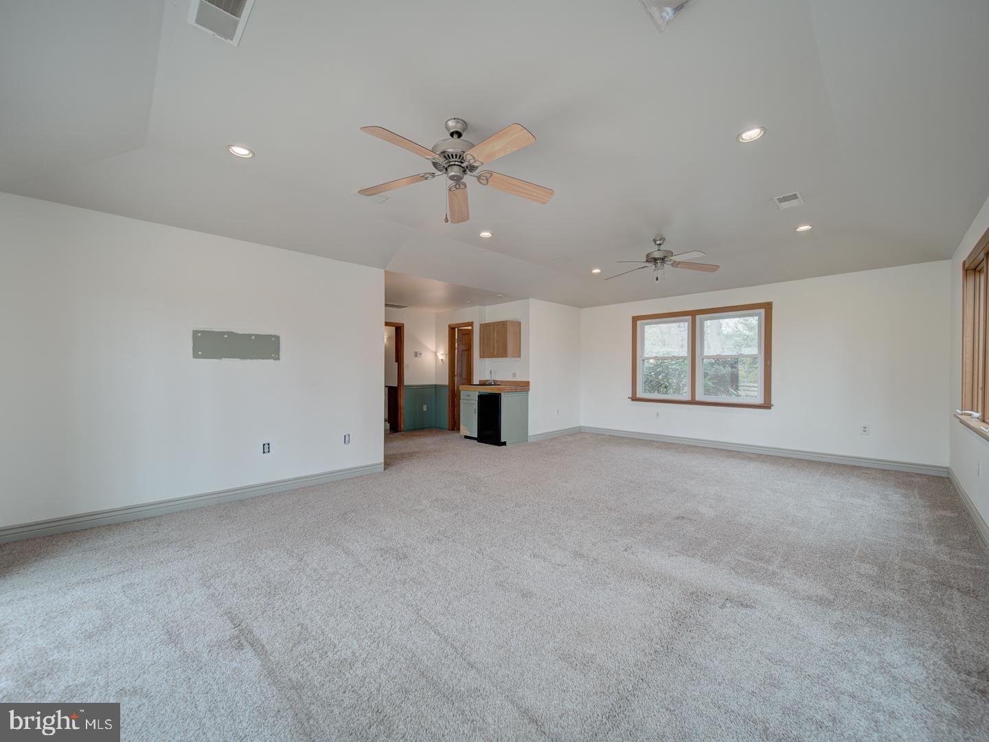 17520 Tranquility Road Purcellville, VA 20132 - Photo 54 of 70 a view of a livingroom with a ceiling fan and window
