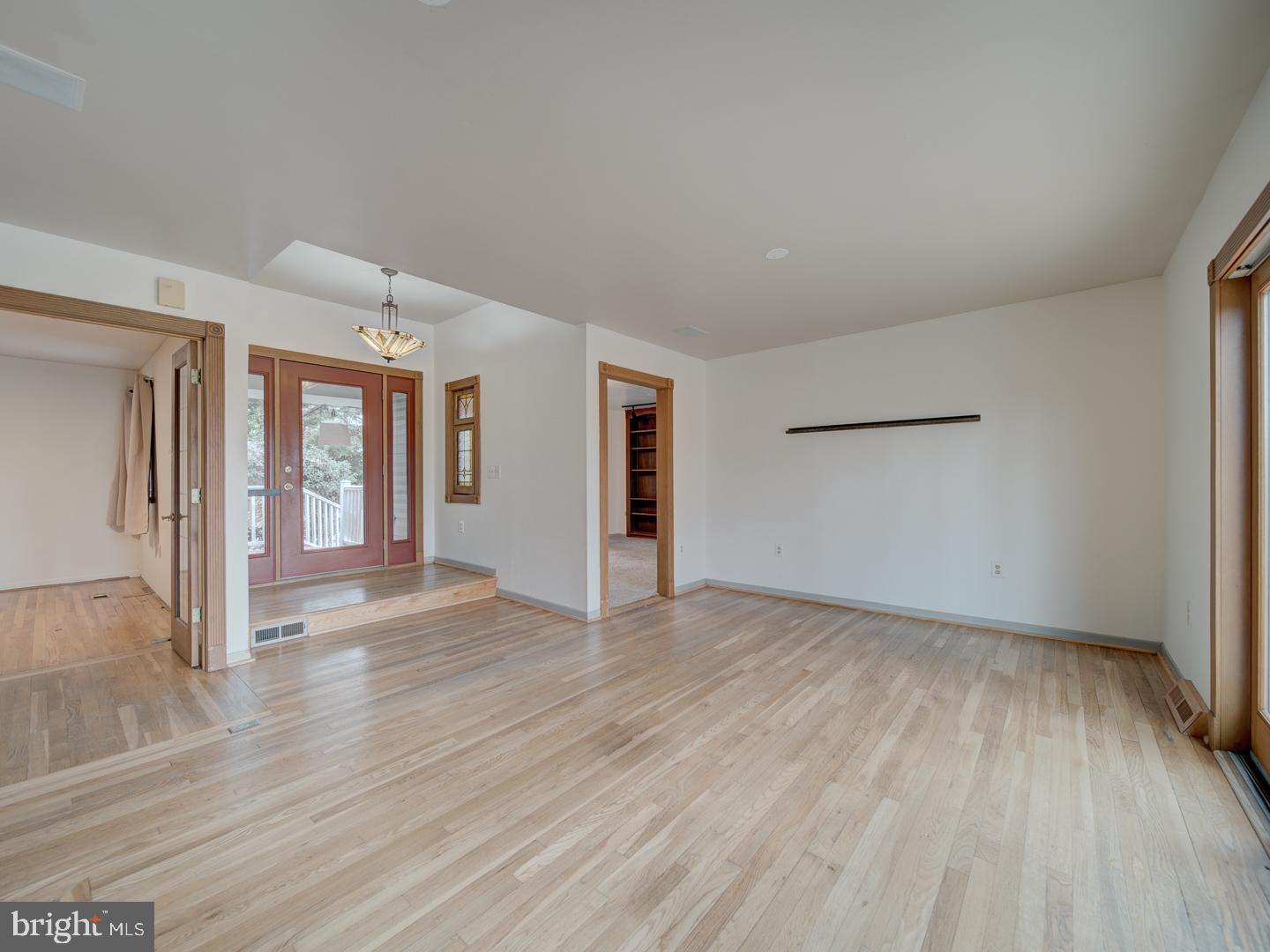 17520 Tranquility Road Purcellville, VA 20132 - Photo 7 of 70 a view of an empty room with wooden floor and a window
