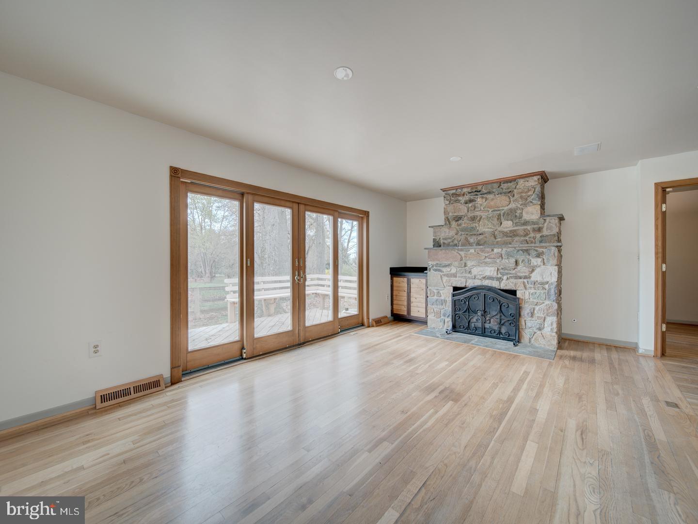 17520 Tranquility Road Purcellville, VA 20132 - Photo 9 of 70 a view of an empty room with a fireplace and a window