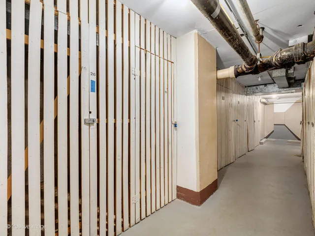 a view of a hallway with wooden cabinets