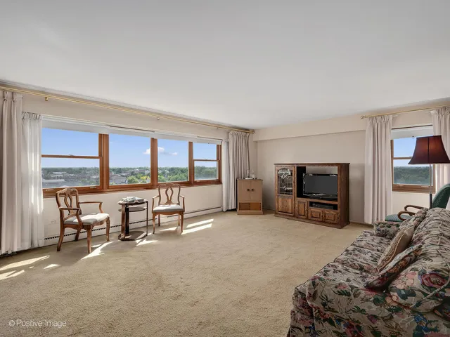 a bed room with furniture and a flat screen tv
