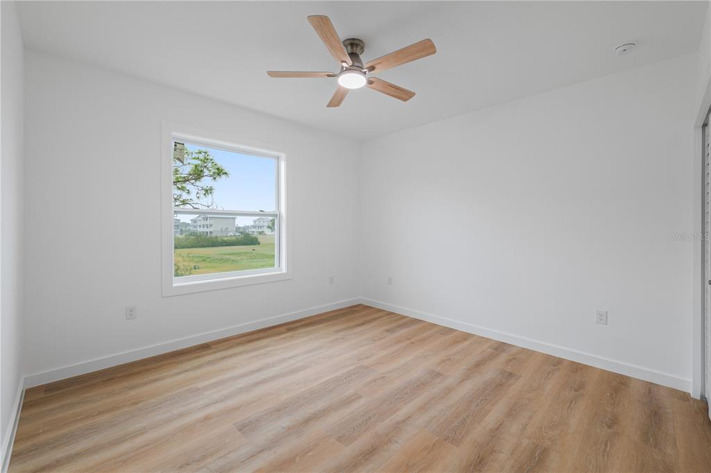 4829 Jenny Way New Port Richey, FL 34652 - Photo 14 of 30 wooden floor in an empty room with a window