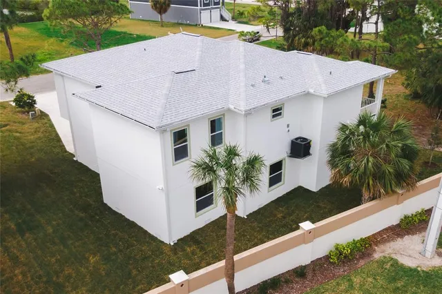 an aerial view of a house with a yard