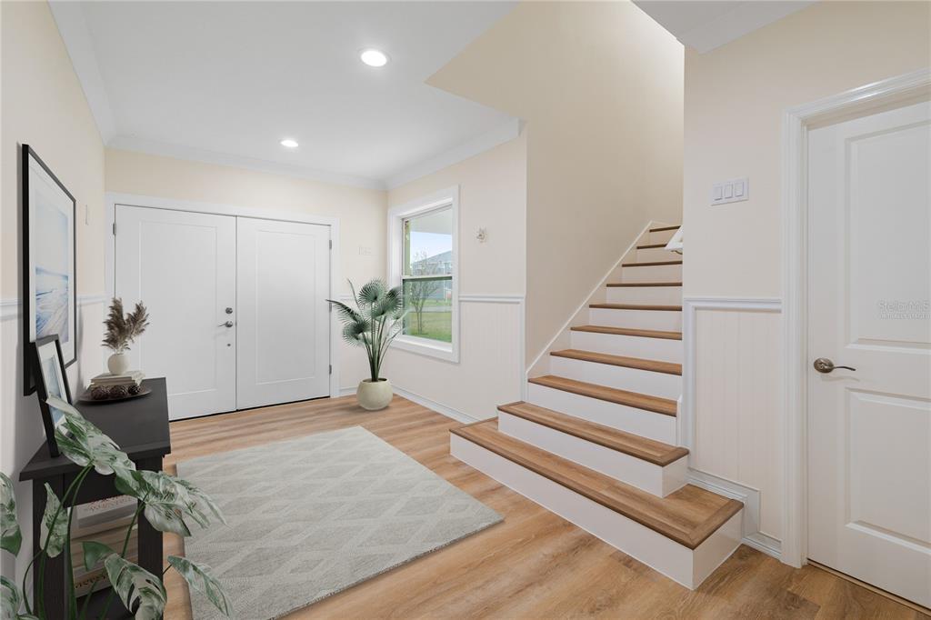 4829 Jenny Way New Port Richey, FL 34652 - Photo 3 of 30 a view of a livingroom with wooden floor and stairs
