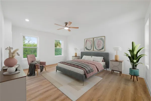 a spacious bedroom with a bed and a chandelier