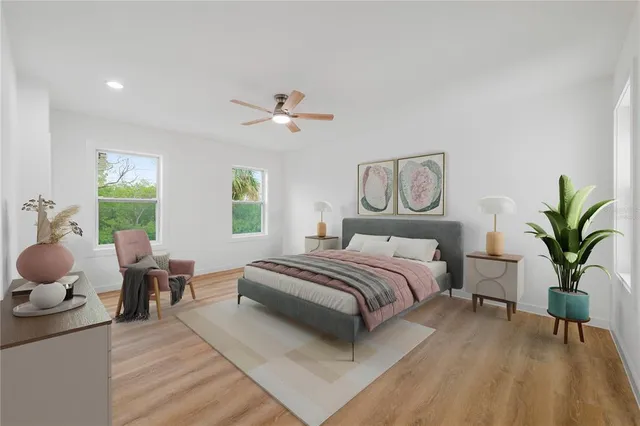 a spacious bedroom with a bed and a chandelier