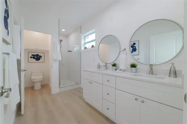 a spacious bathroom with a granite countertop sink mirror and toilet