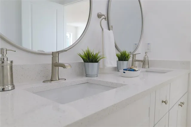 a view of bathroom with a sink and mirror