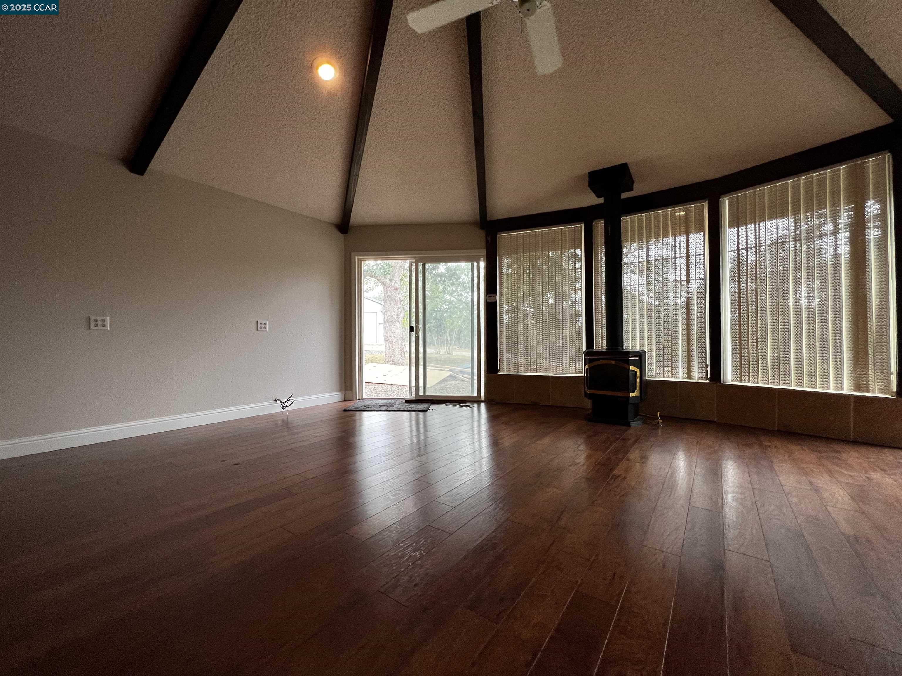 14630 St Croy Road Red Bluff, CA 96080 - Photo 17 of 29 an empty room with wooden floor and windows with curtains