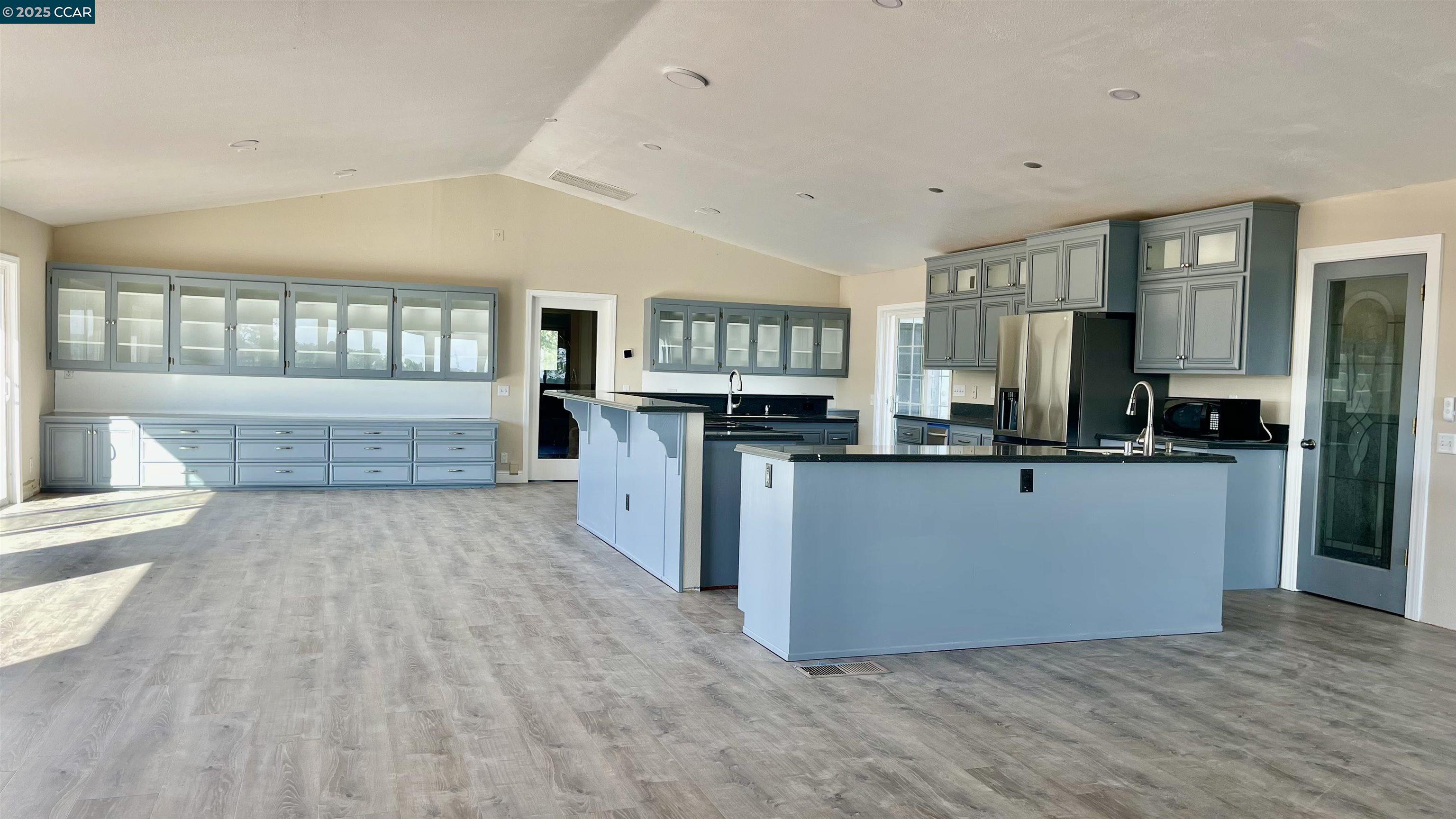 14630 St Croy Road Red Bluff, CA 96080 - Photo 2 of 29 a living room with kitchen island granite countertop wooden floor and a fireplace