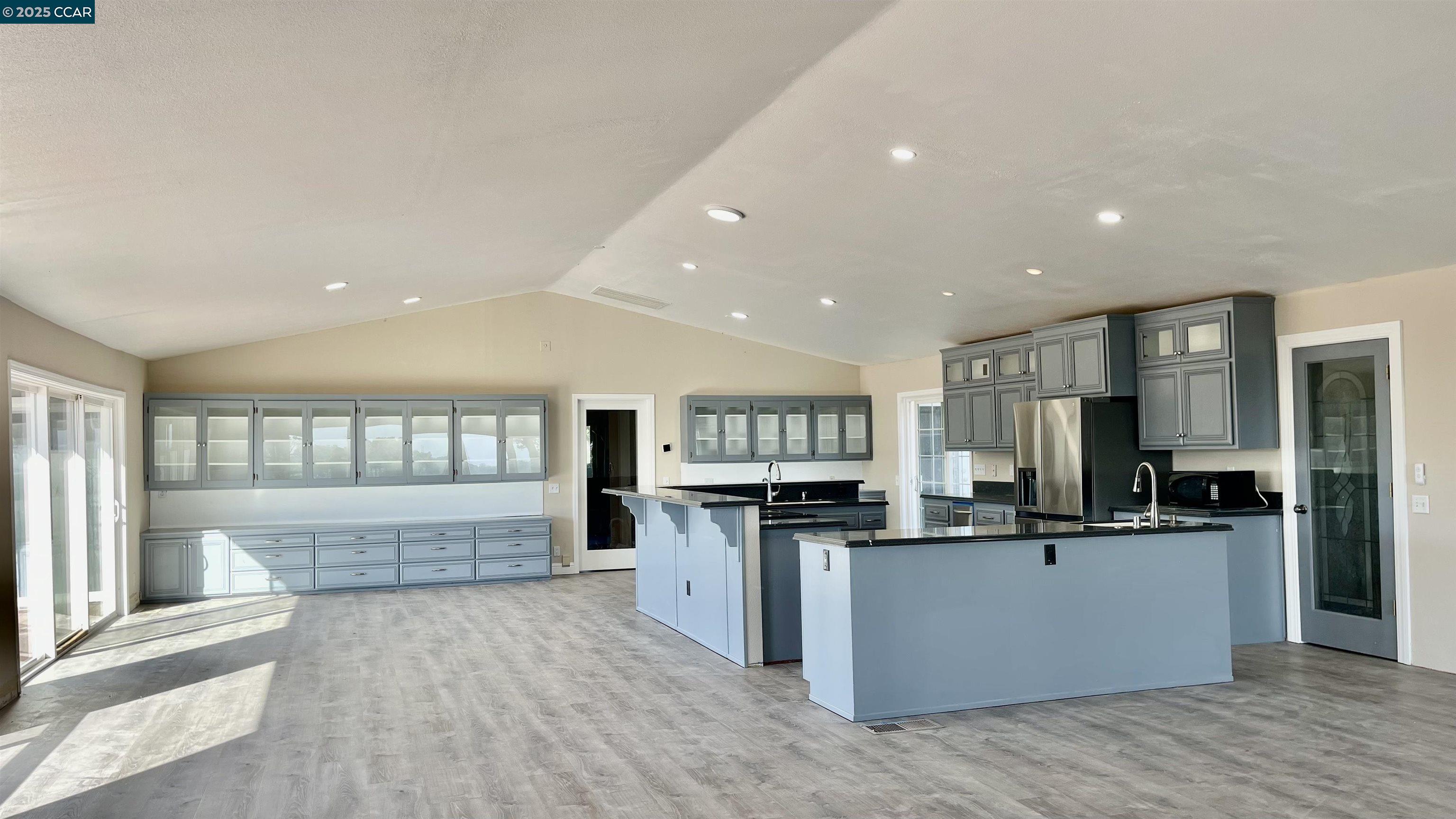 14630 St Croy Road Red Bluff, CA 96080 - Photo 3 of 29 a kitchen with stainless steel appliances kitchen island granite countertop a refrigerator and a stove top oven