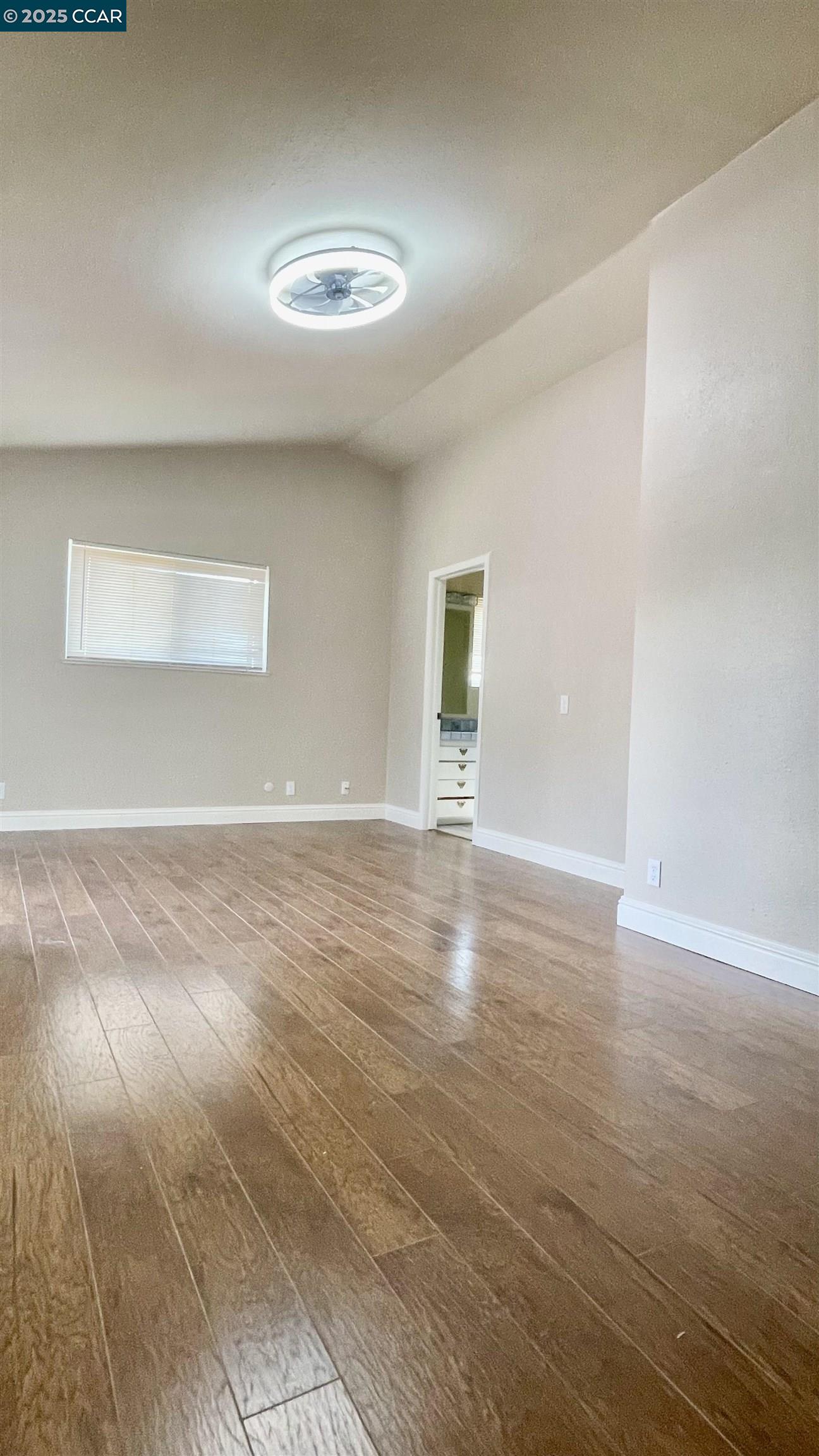 14630 St Croy Road Red Bluff, CA 96080 - Photo 9 of 29 an empty room with wooden floor and windows
