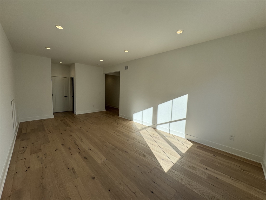 12 Old County Road, Unit 20 Hudson, MA 01749 - Photo 29 of 30 an empty room with wooden floor and windows