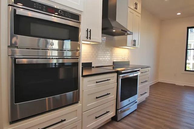 a kitchen with stainless steel appliances and cabinets