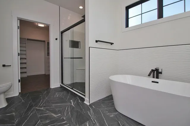 a bathroom with a bathtub and toilet