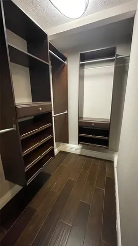 a view of walk in closet with empty racks