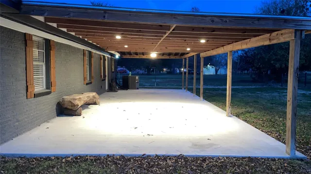 a view of a backyard with large tree