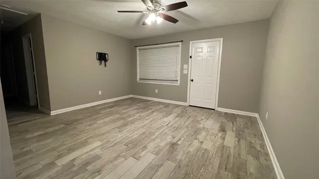 a view of a kitchen with wooden floor and a sink