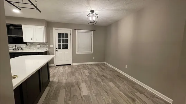 a kitchen with kitchen island a sink dishwasher stove and refrigerator