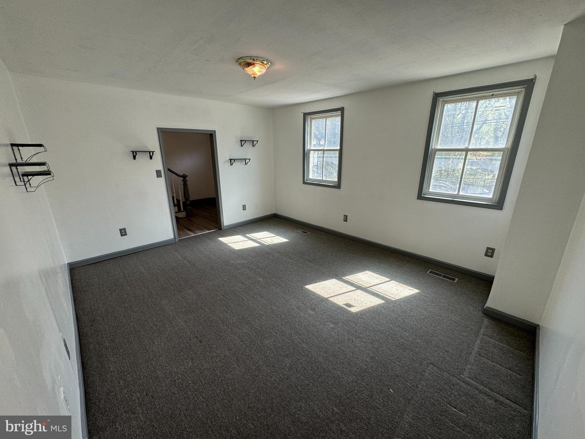413 South Braddock Street Winchester, VA 22601 - Photo 3 of 20 an empty room with windows and closet