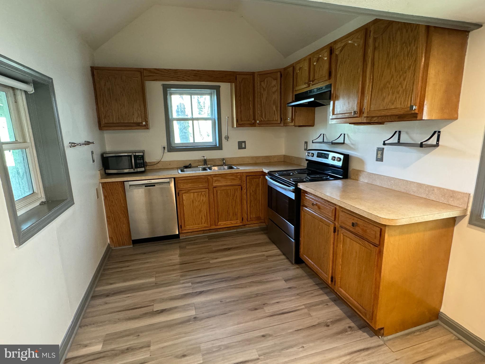 413 South Braddock Street Winchester, VA 22601 - Photo 4 of 20 a kitchen with stainless steel appliances granite countertop wooden cabinets a stove top oven a sink and dishwasher