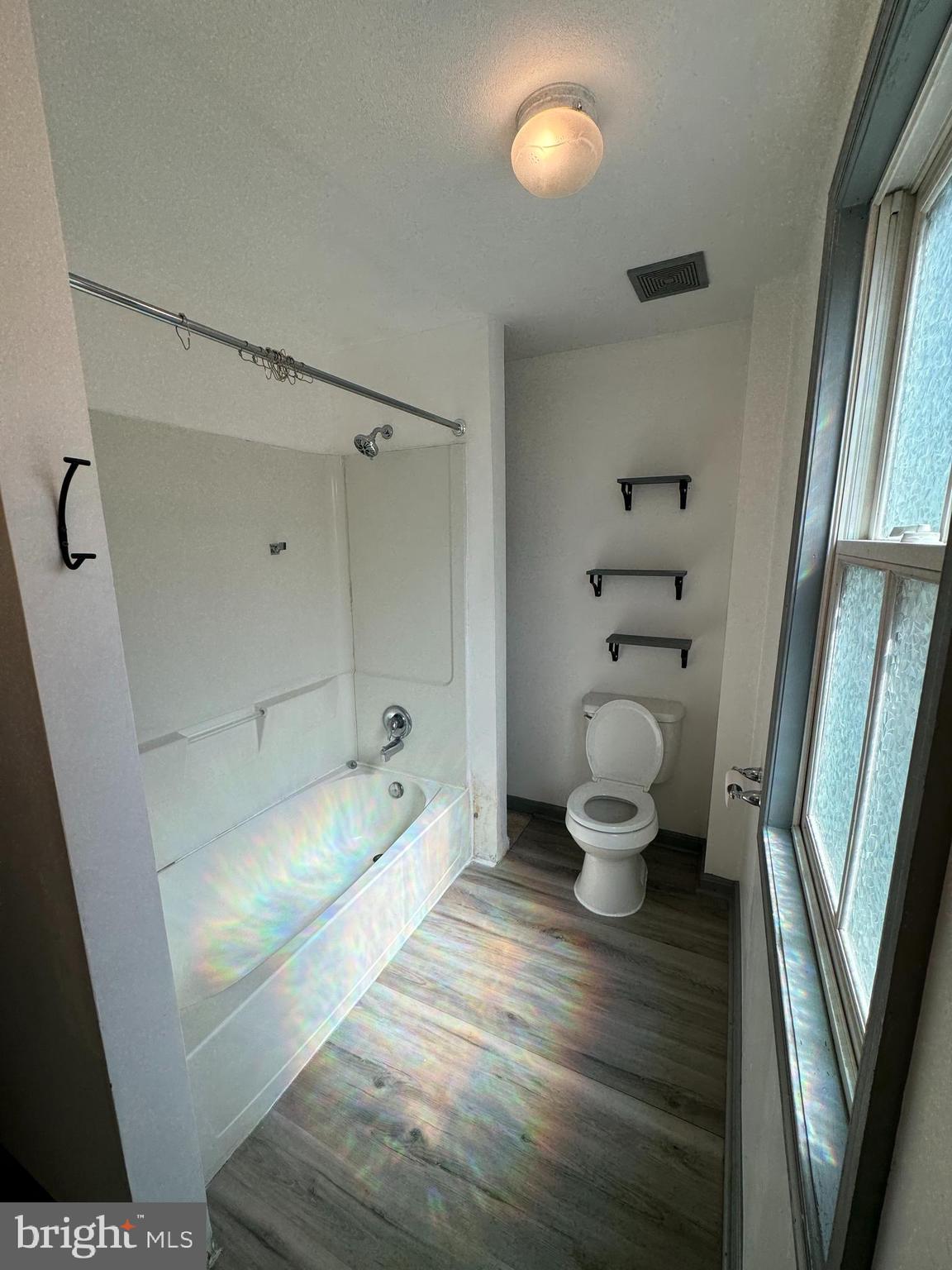 413 South Braddock Street Winchester, VA 22601 - Photo 9 of 20 a bathroom with a toilet and a shower
