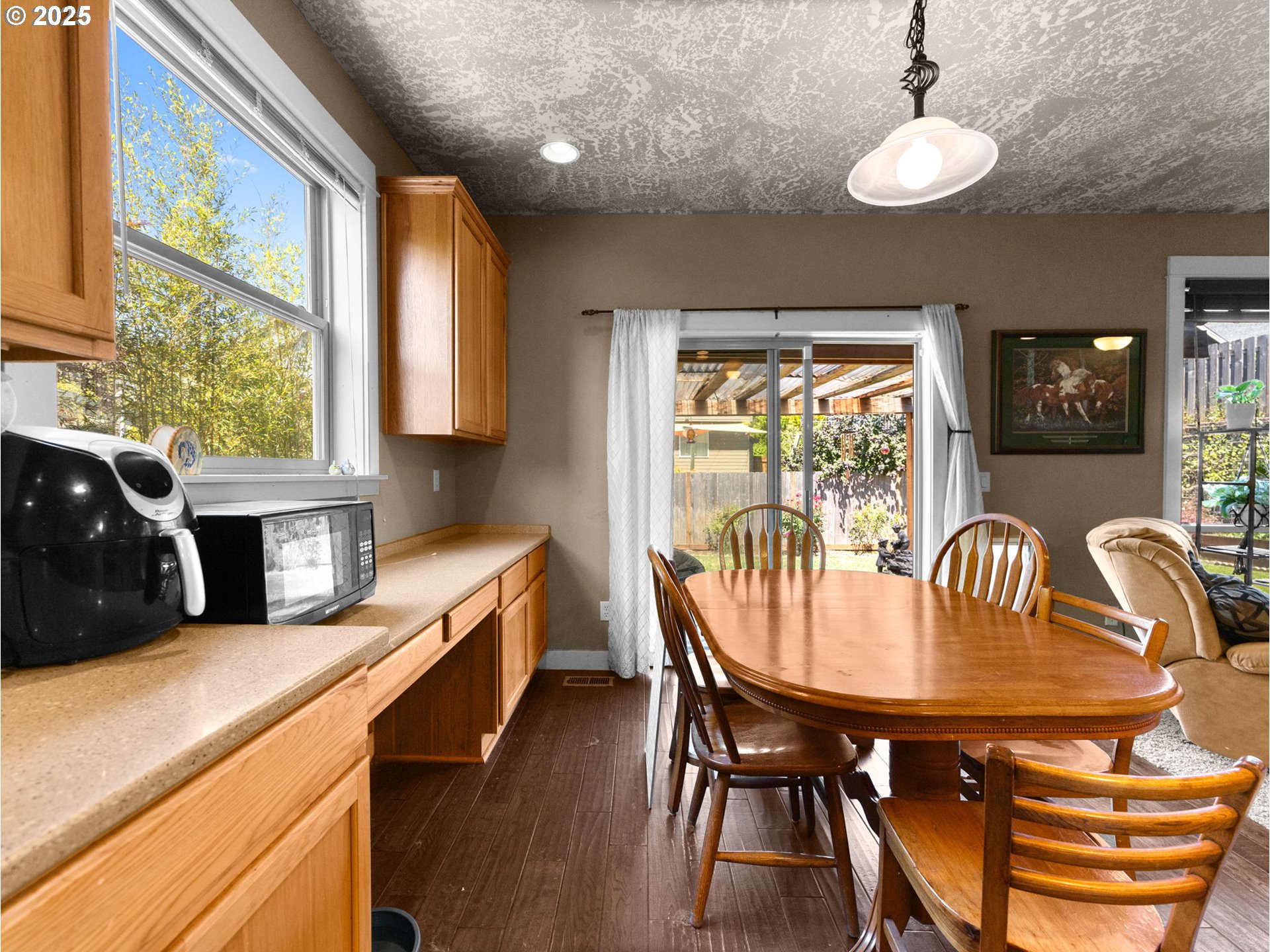 18653 Van Fleet Avenue Sandy, OR 97055 - Photo 17 of 48 a kitchen with stainless steel appliances granite countertop a stove a sink a dining table and chairs
