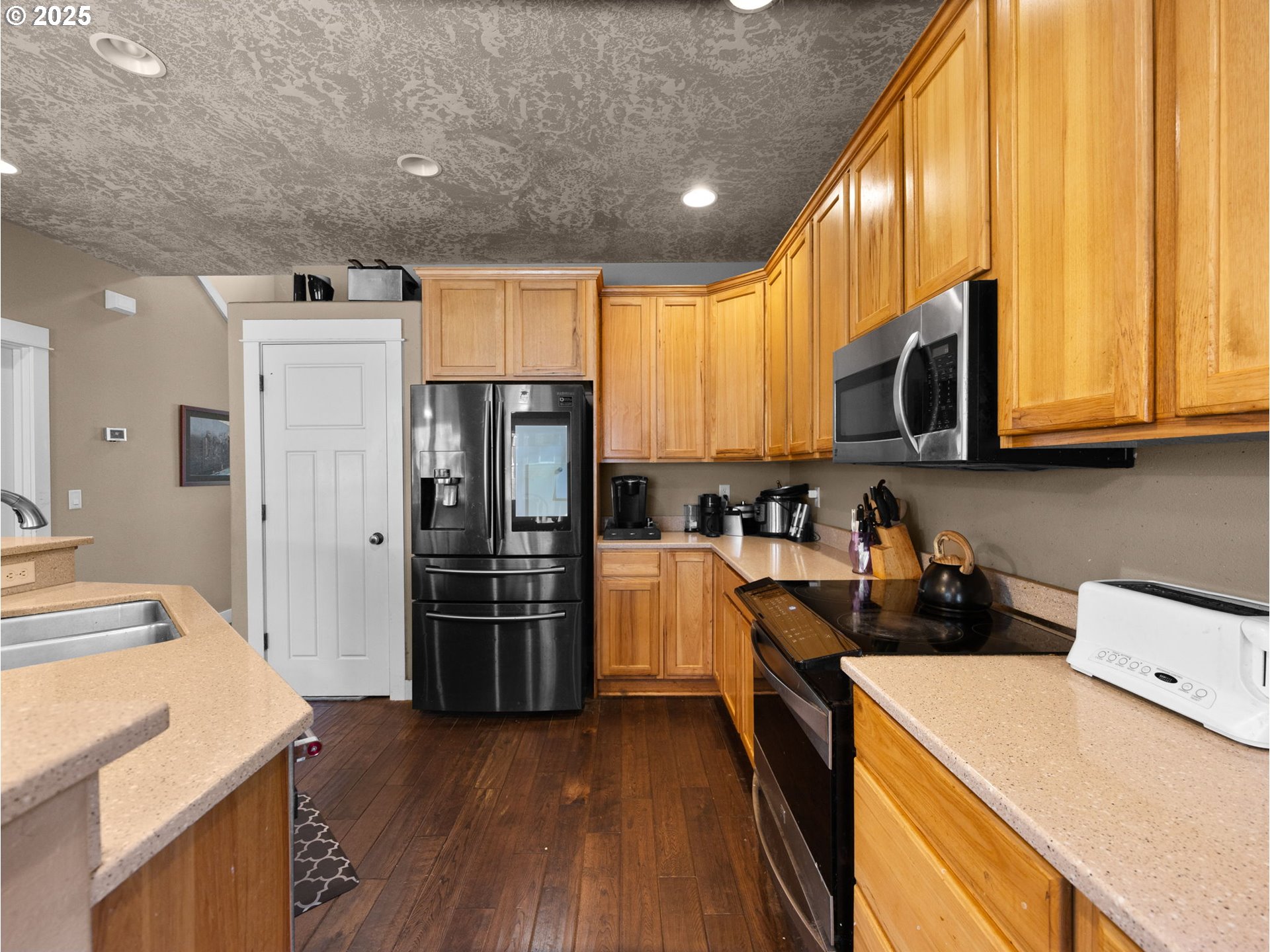 18653 Van Fleet Avenue Sandy, OR 97055 - Photo 18 of 48 a kitchen with stainless steel appliances a refrigerator a stove a sink dishwasher and a microwave oven with wooden floor