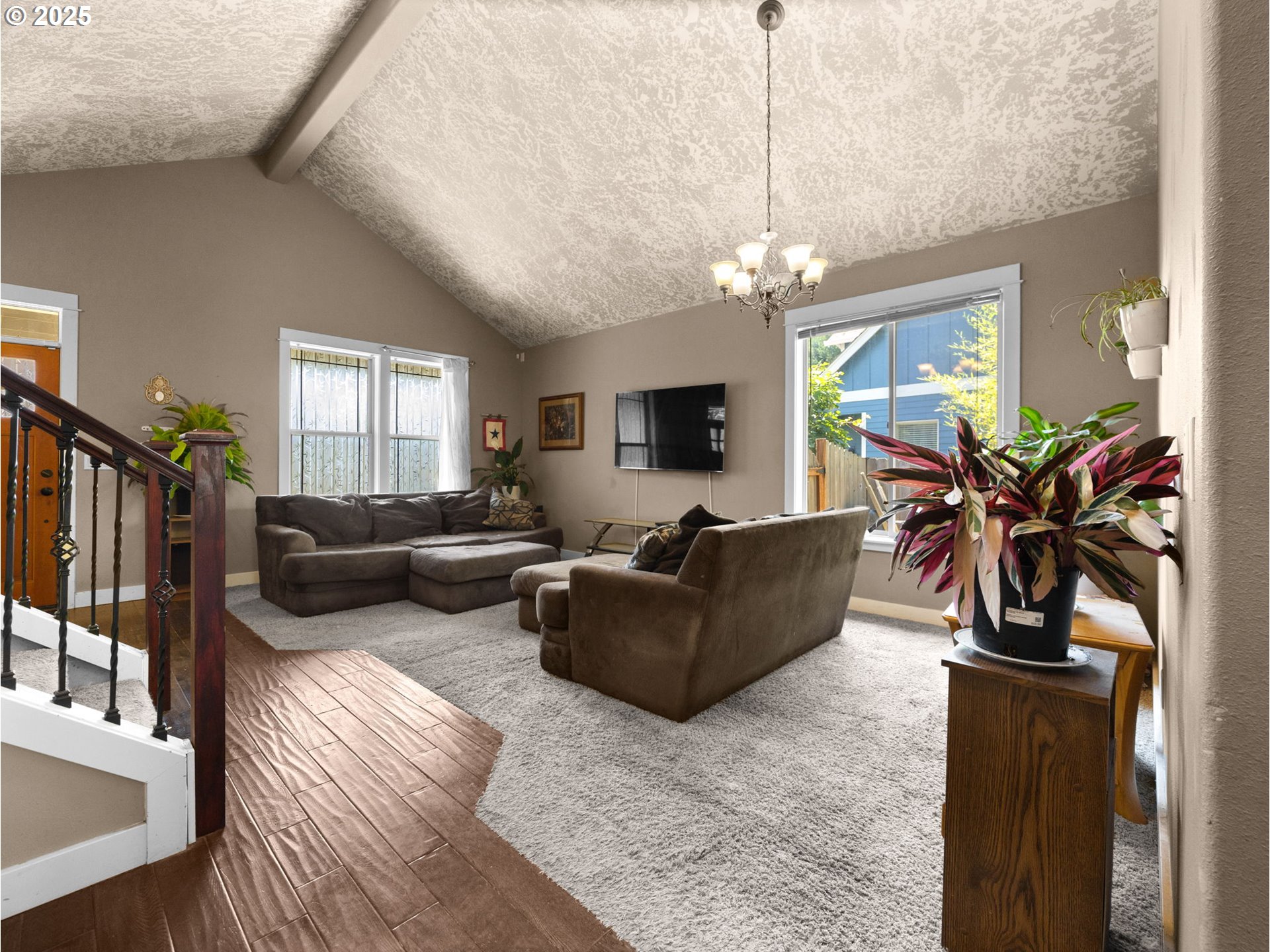 18653 Van Fleet Avenue Sandy, OR 97055 - Photo 7 of 48 a living room with furniture a chandelier and a flat screen tv