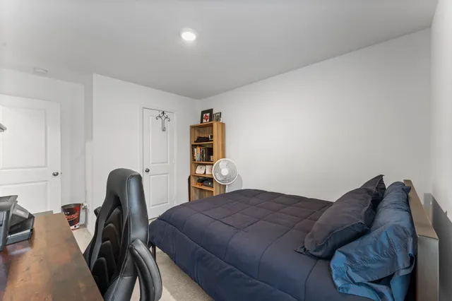 a bedroom with a bed and a chair