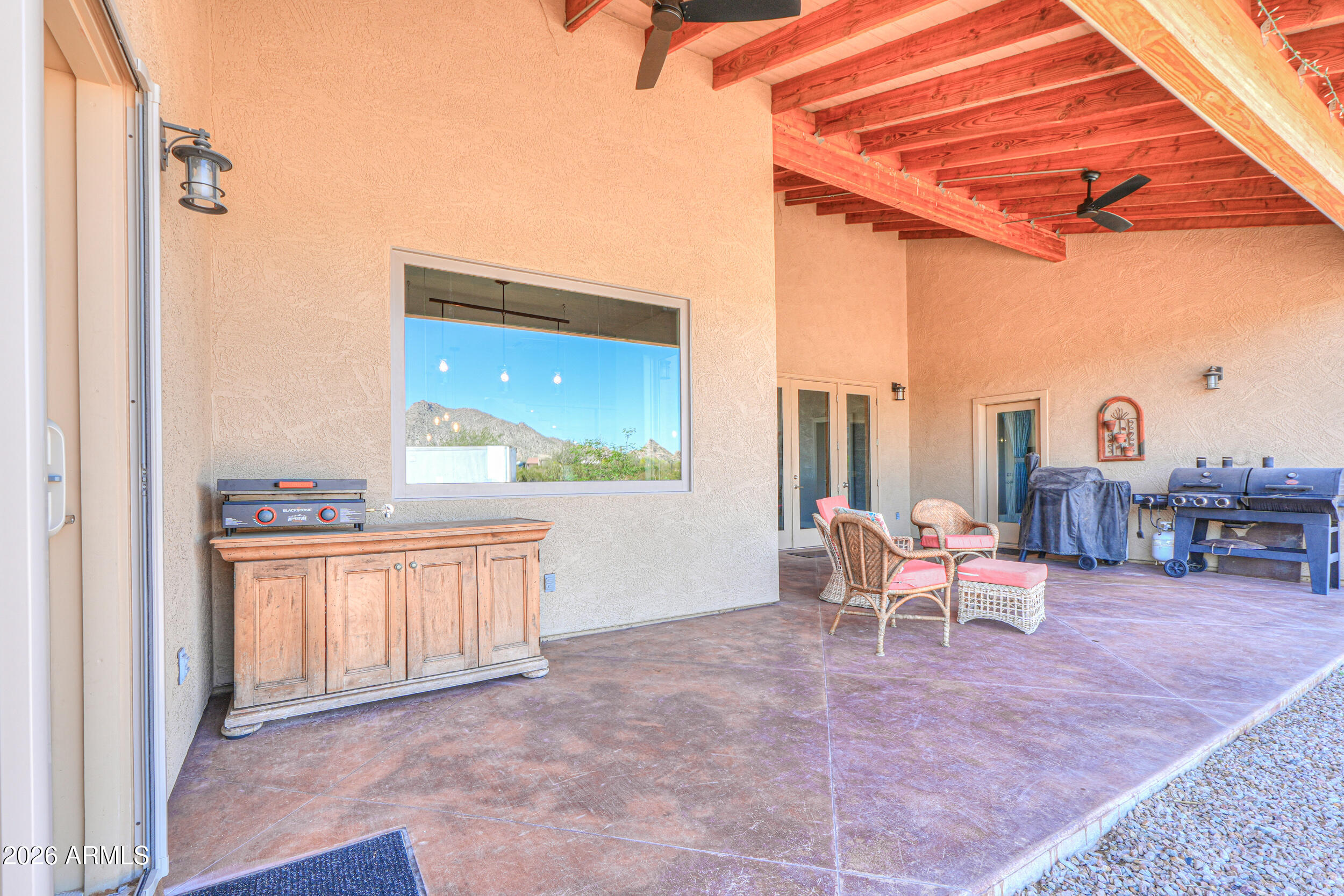 11422 North Hazeldine Road Casa Grande, AZ 85194 - Photo 46 of 59 a living room with furniture a large window and a fireplace