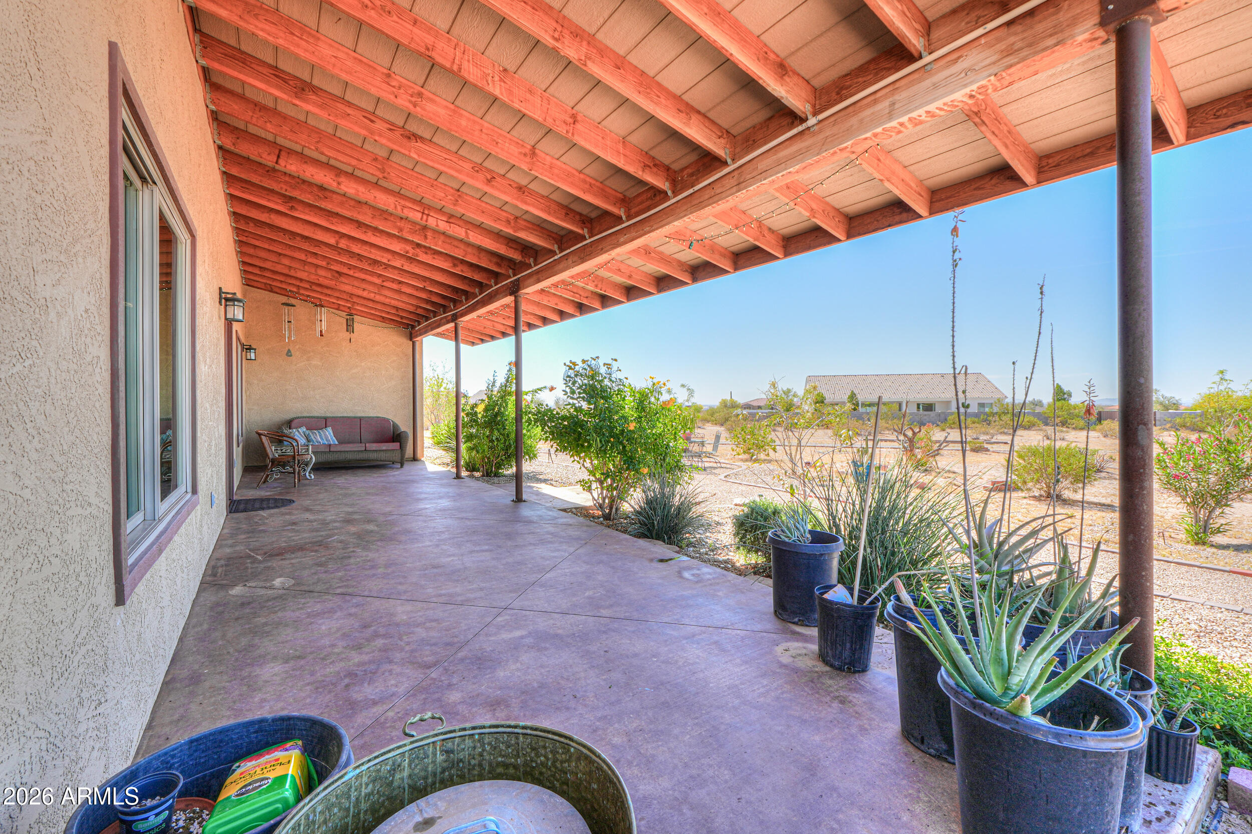 11422 North Hazeldine Road Casa Grande, AZ 85194 - Photo 5 of 59 a view of a backyard with plants and a patio