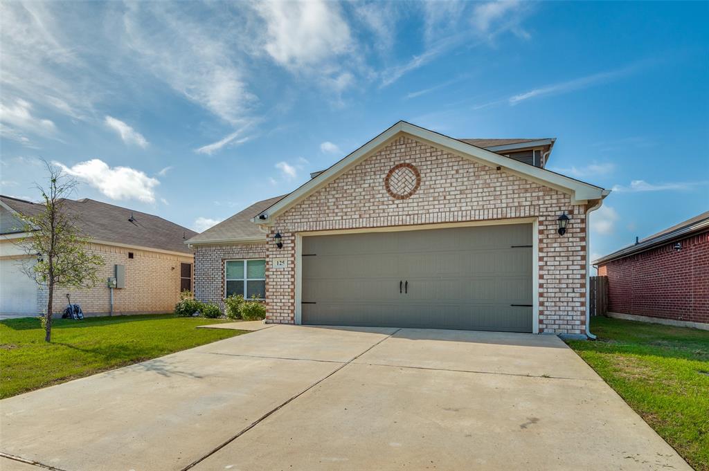 125 Sammy Venus, TX 76084 - Photo 22 of 39 Single-story residence featuring light-colored brick veneer, a two-car garage with a dark gray door, and a concrete driveway