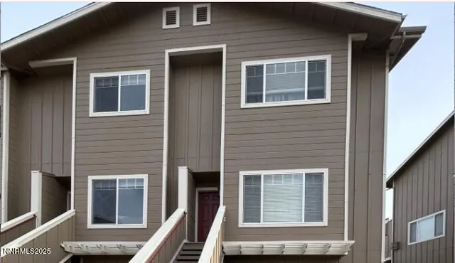 a front view of a house with many windows